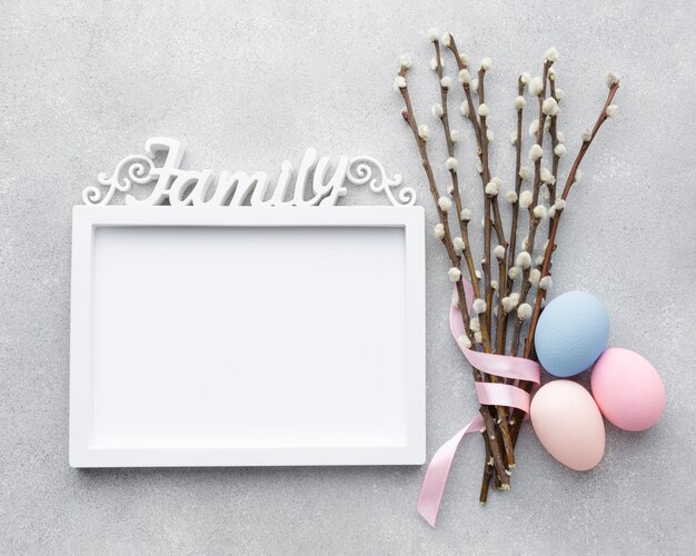 Flat lay of frame with easter eggs and flowers