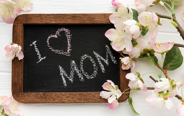 Flat lay frame with flowers beside