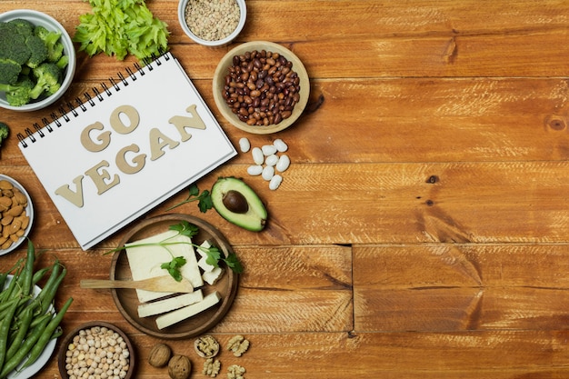 Flat lay frame with healthy food on wooden background