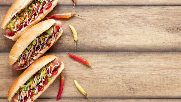 Free photo flat lay frame with hot dogs and peppers