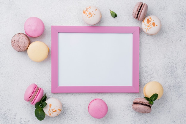 Flat lay of frame with macarons and mint