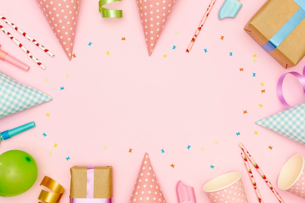 Free photo flat lay frame with party items and pink background