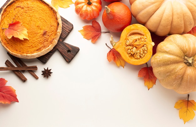 Flat lay frame with pumpkins and pie