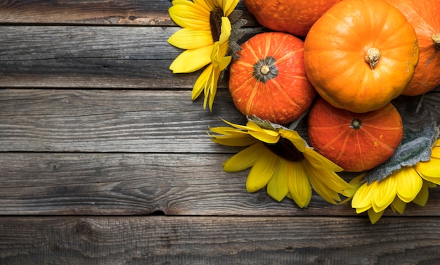 Flat lay frame with pumpkins on wooden background