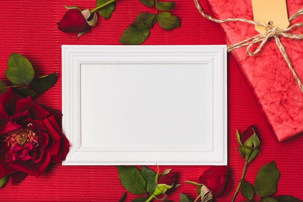 Flat lay of frame with roses and present