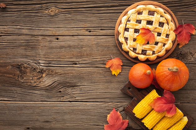 Flat lay frame with tasty pie and corn