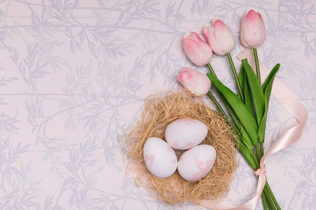 Flat lay frame with tulips and eggs