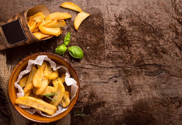 Flat lay of french fries with copy space and herbs