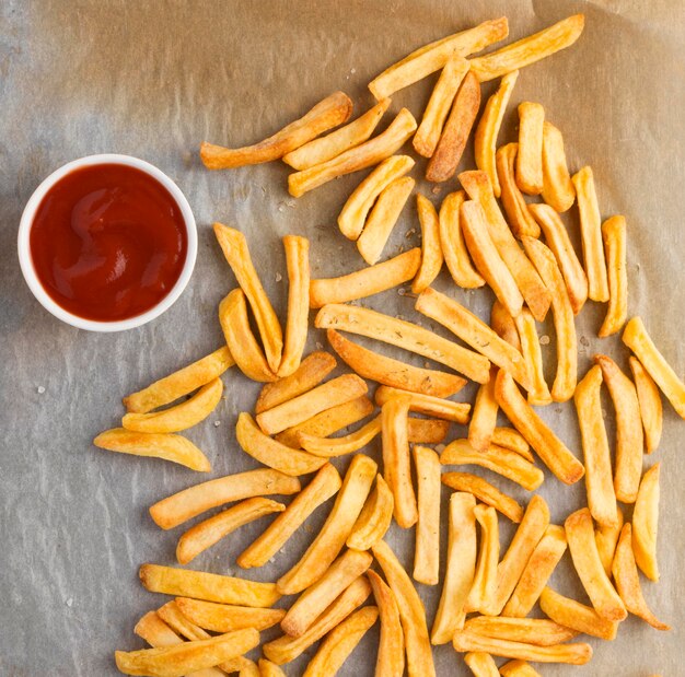 Flat lay of french fries with ketchup sauce