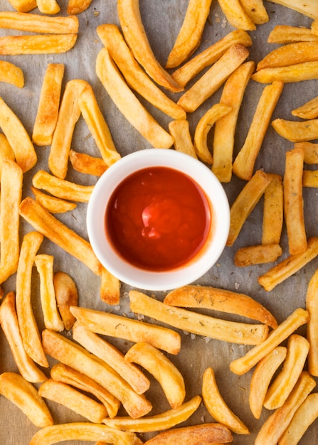 Flat lay of french fries with ketchup