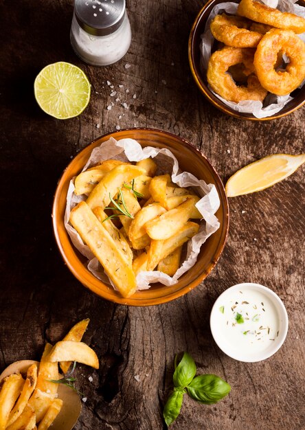 Flat lay of french fries with salt shaker and special sauce