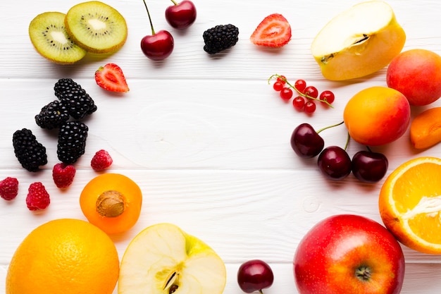 Flat-lay of fresh berries and fruits frame