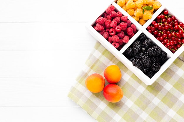 Flat-lay fresh berries on tablecloth  with copy space