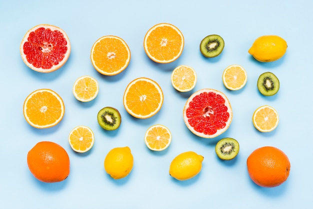 Flat lay of fresh citrus fruits and kiwis