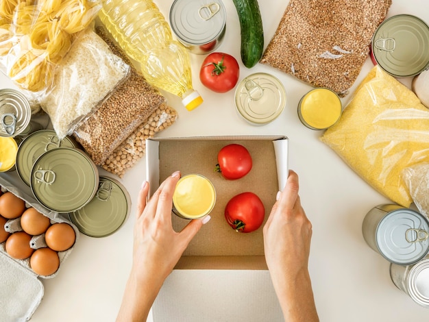 Flat lay of fresh provisions for donation with box