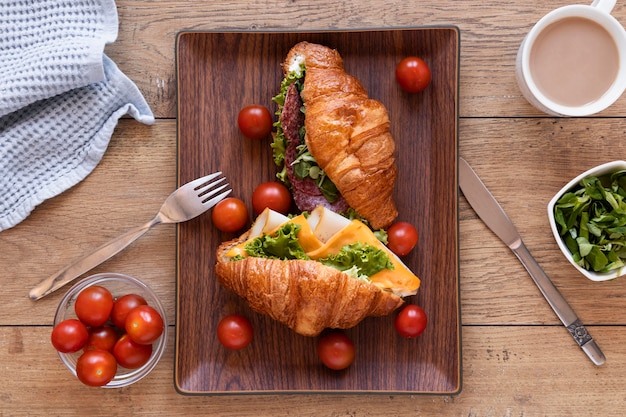 Flat lay fresh sandwiches arrangement on wooden background