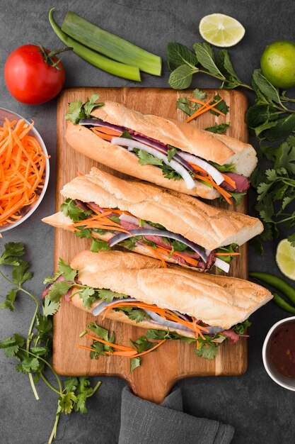 Flat lay of fresh sandwiches on chopping board