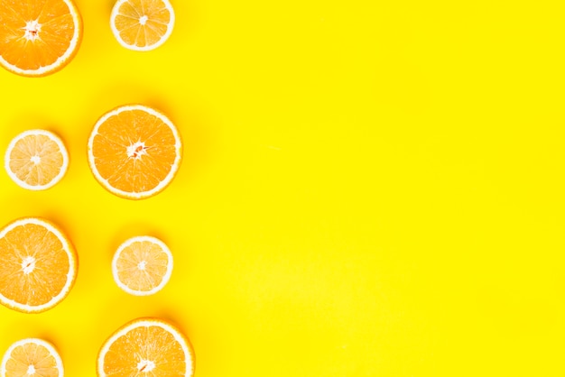 Flat lay of fresh slices of lemons and oranges