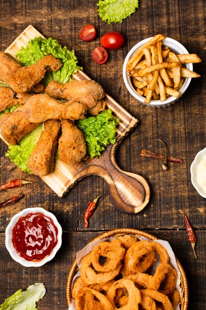 Flat lay of fried drumsticks with french fries