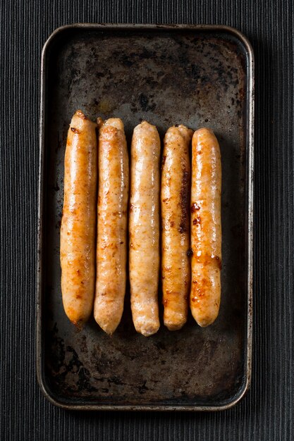 Flat lay fried sausages on tray