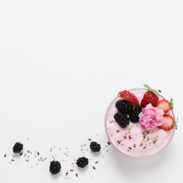 Flat lay of fruit yoghurt with rose