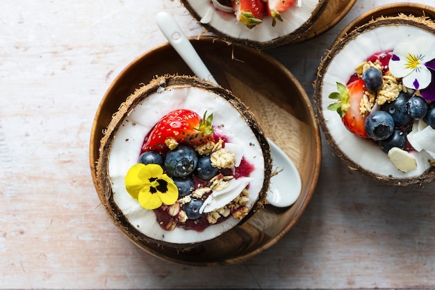 Flat lay fruits and grains in coconut shell tropical vibes