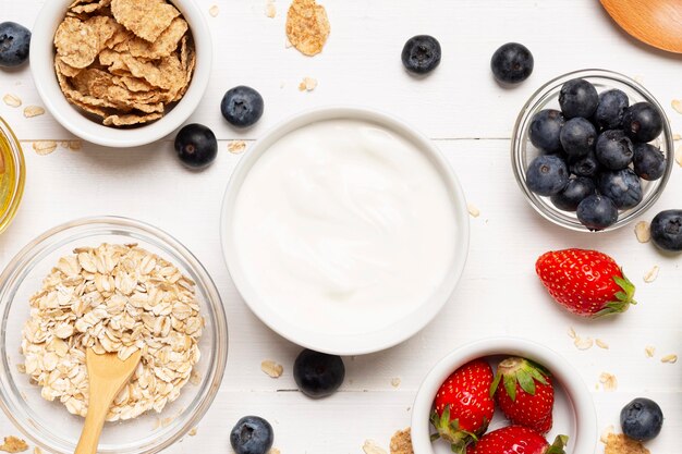 Flat lay fruits and sour cream bowls