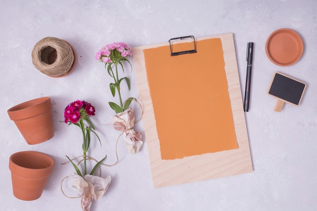 Flat lay gardening concept with clipboard