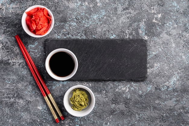 Flat lay ginger wasabi and soy sauce bowls on table