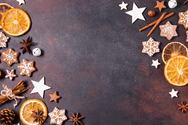 Flat lay of gingerbread cookies and dried citrus for christmas with copy space