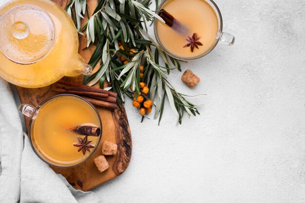 Flat lay glasses with flavored fruit juice and cinnamon