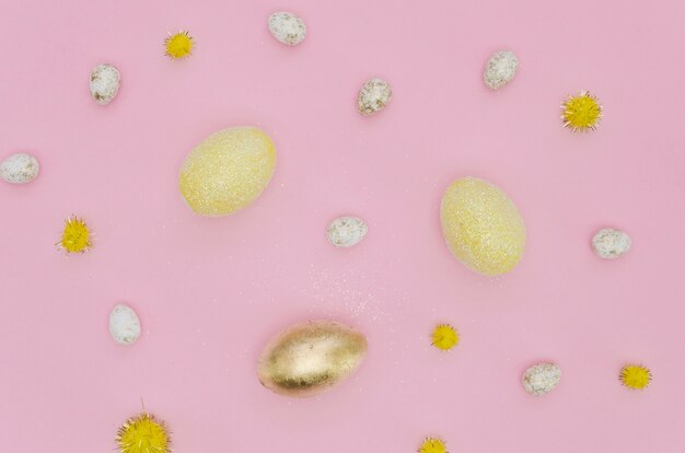 Flat lay of golden easter egg with dandelions