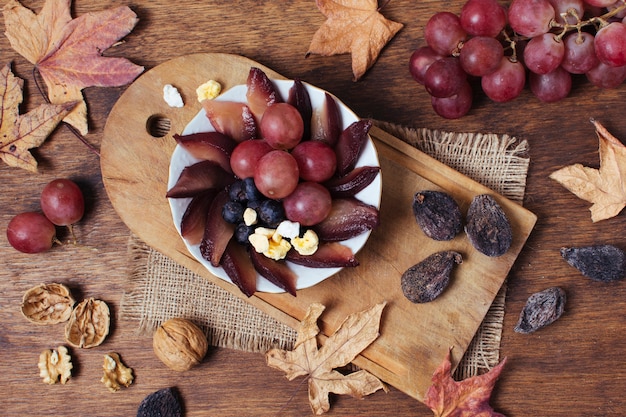 Free photo flat lay goodies on plate next to leaves