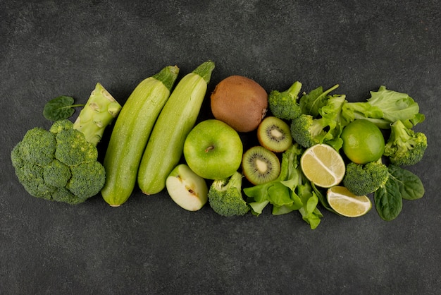 Flat lay green fruits and vegetables arrangement