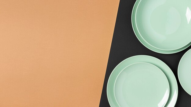 Flat lay green plates composition with copy space