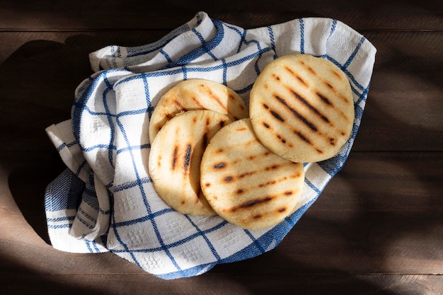 Flat lay grilled arepas on towel