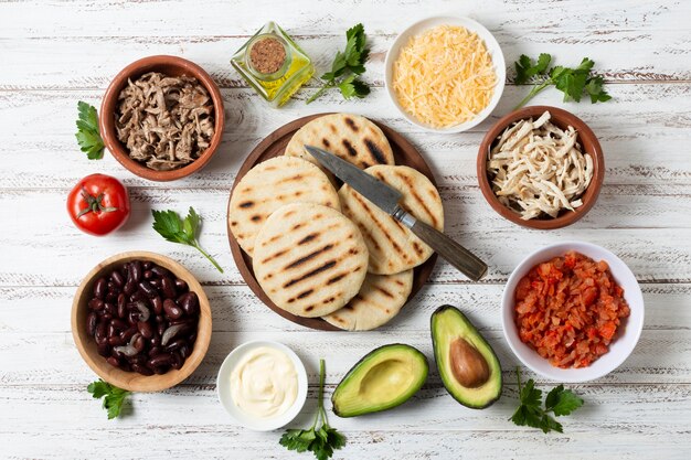 Flat lay grilled arepas on wooden board