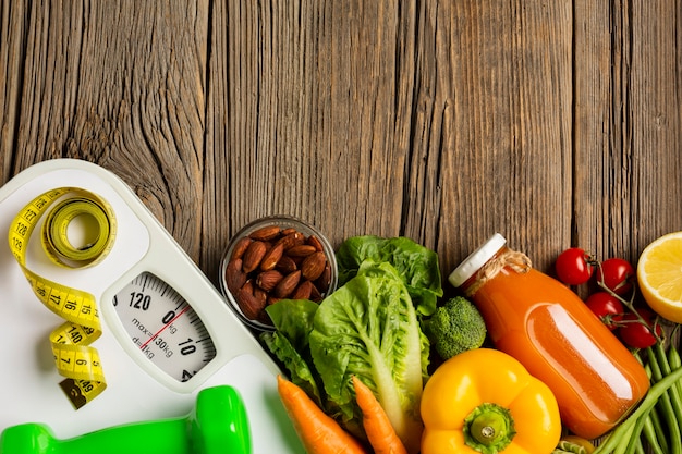 Flat lay of groceries and scale on wood table