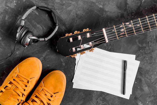 Flat lay of guitar and music notes