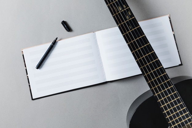 Flat lay of guitar and music notes