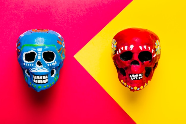 Flat lay halloween decoration with colourful skulls
