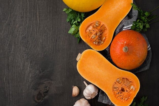 Flat lay halved pumpkin arrangement with copy space