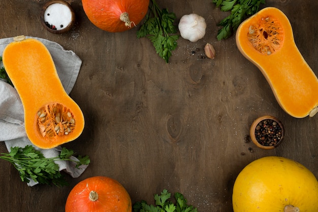 Flat lay halved pumpkin assortment with copy space