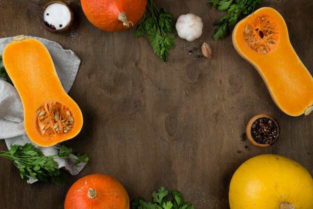 Flat lay halved pumpkin assortment with copy space