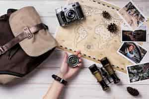 Free photo flat lay hand holding compass