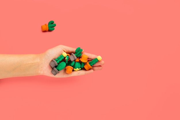 Flat lay of hand holding sponge on plain background