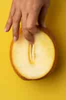 Free photo flat lay hand touching melon