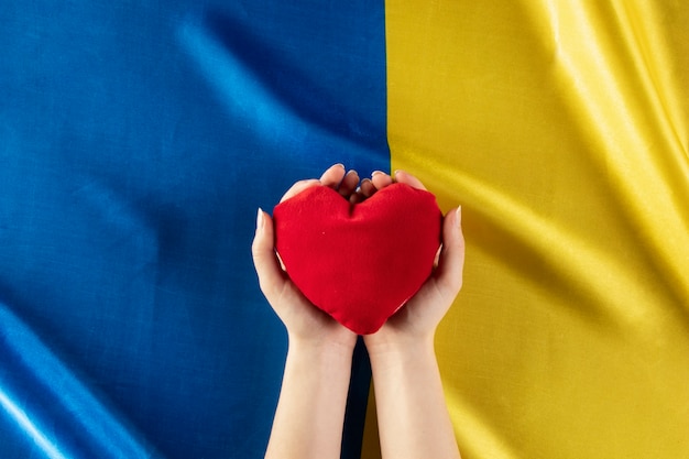 Free photo flat lay hands holding red heart