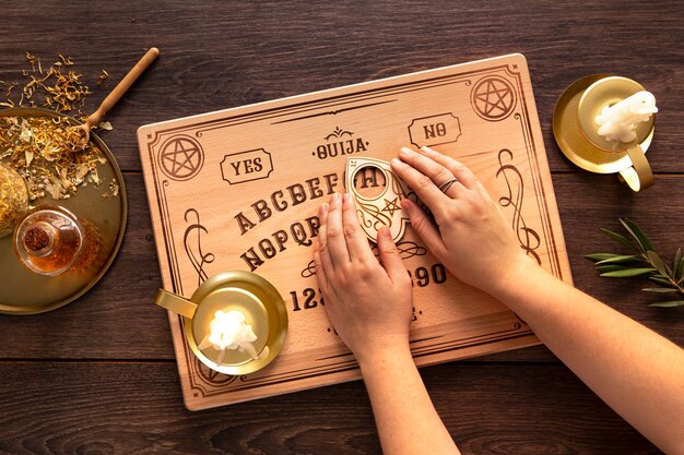 Flat lay hands using ouija board tool