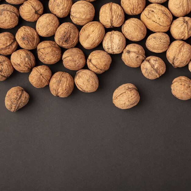 Flat lay of hard shell walnuts with copy space